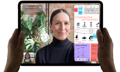 iPad Pro, front exterior, landscape orientation, space black colour, rounded corners, black display bezel, hands holding left and right sides, display showing a FaceTime conversation being live translated, and an educational app showing a presentation of “Comparative Mythology” with text, diagrams and handwritten notes